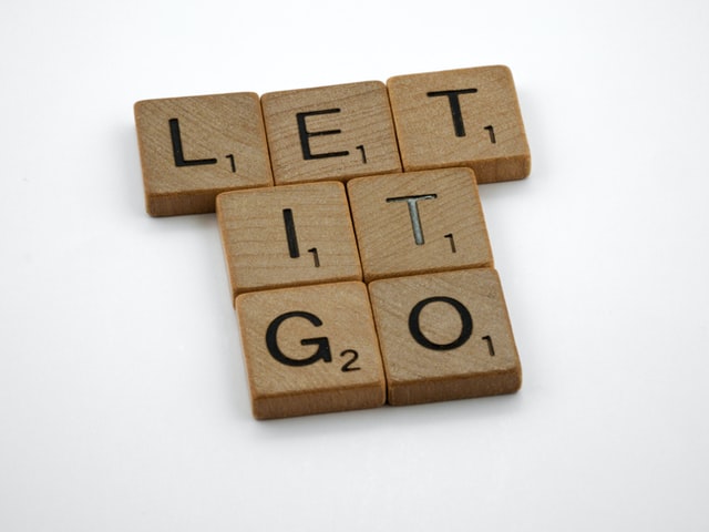 tiny square wooden block with the words let it go
