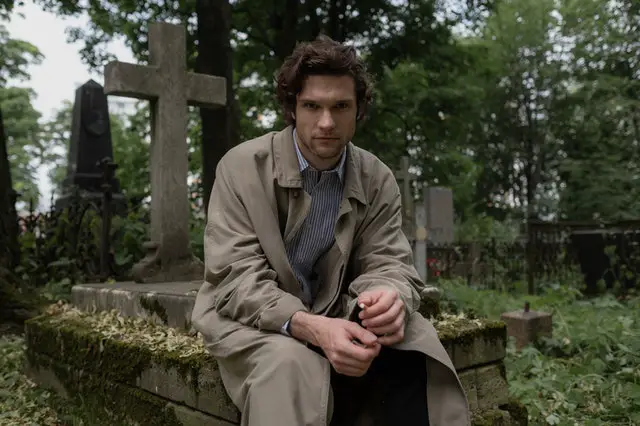 young man in a trench coat sitting in a graveyard - dramatic monologues for men from movies